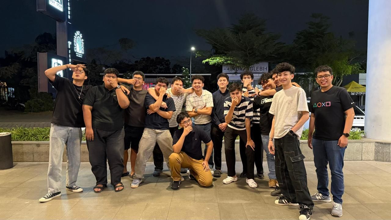 Belasan penghuni berfoto bersama sambil bercanda di depan sebuah restoran pada malam hari setelah makan bareng